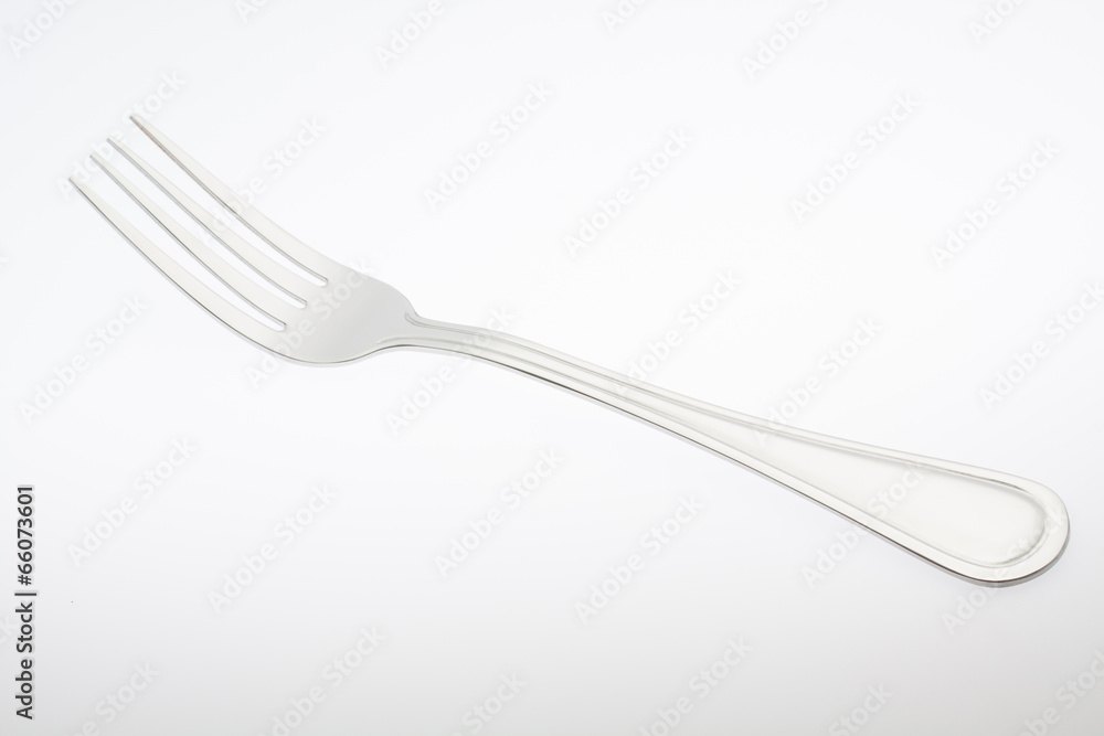 a silver fork isolated on gray background a silver fork isolated on gray background