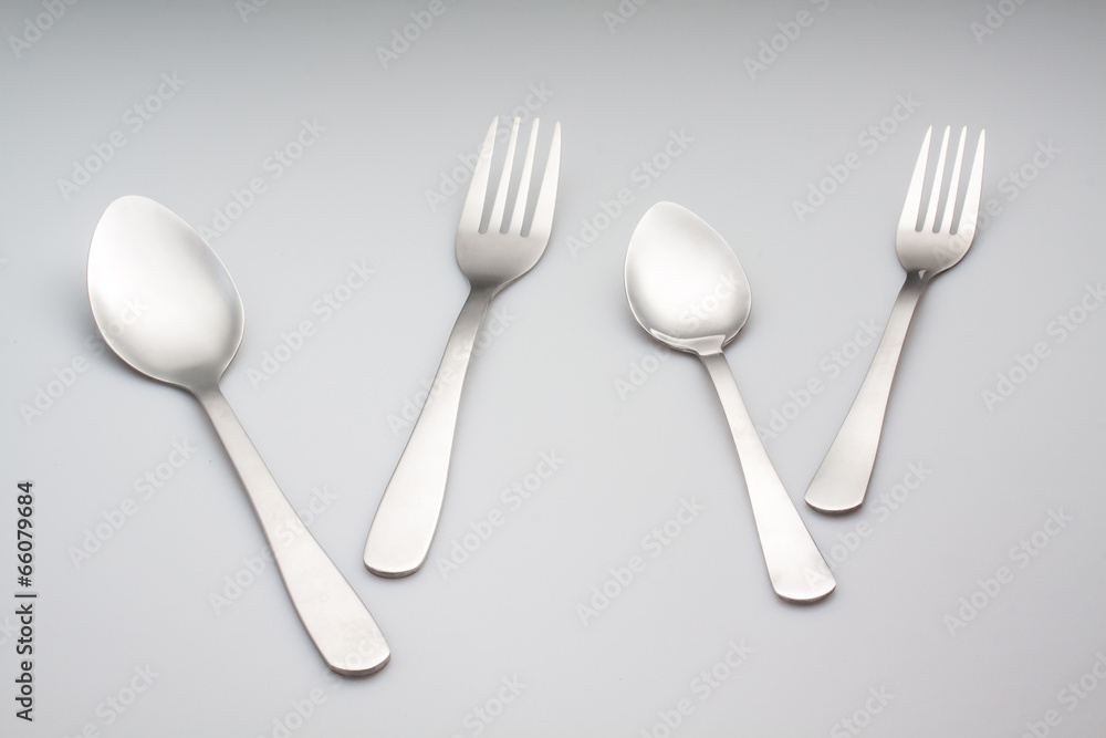 silver fork with spoon isolated on gray background silver fork with spoon isolated on gray background