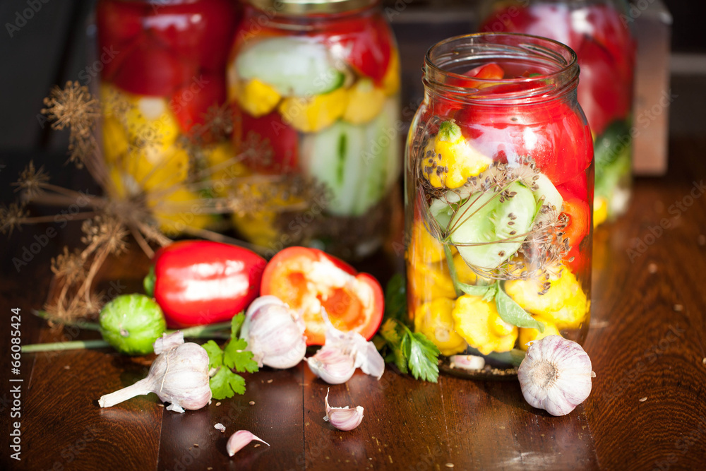 preserved cucumbers, peppers and patisson in jars