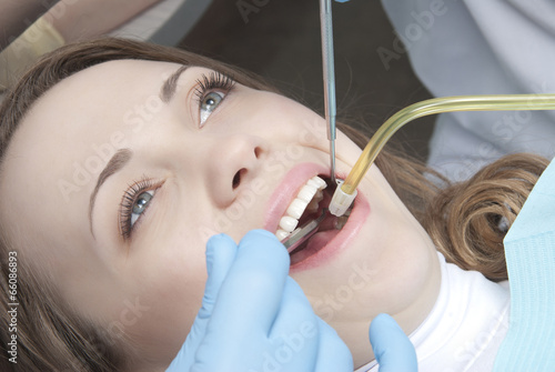 Close-up of young female having her teeth dental care