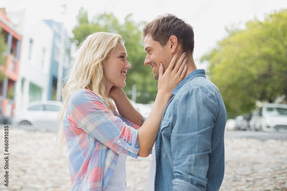 Hip young couple smiling at each other