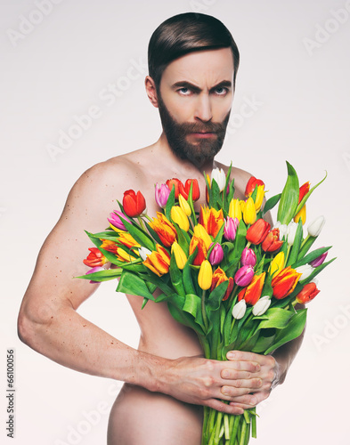 Men portrait with a bouquet of flowers. photo