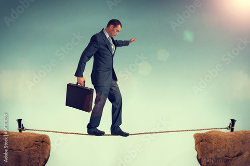 businessman balancing on a tightrope