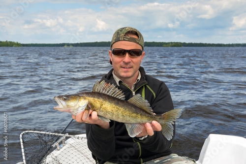 Happy angler with walleye trophy fish