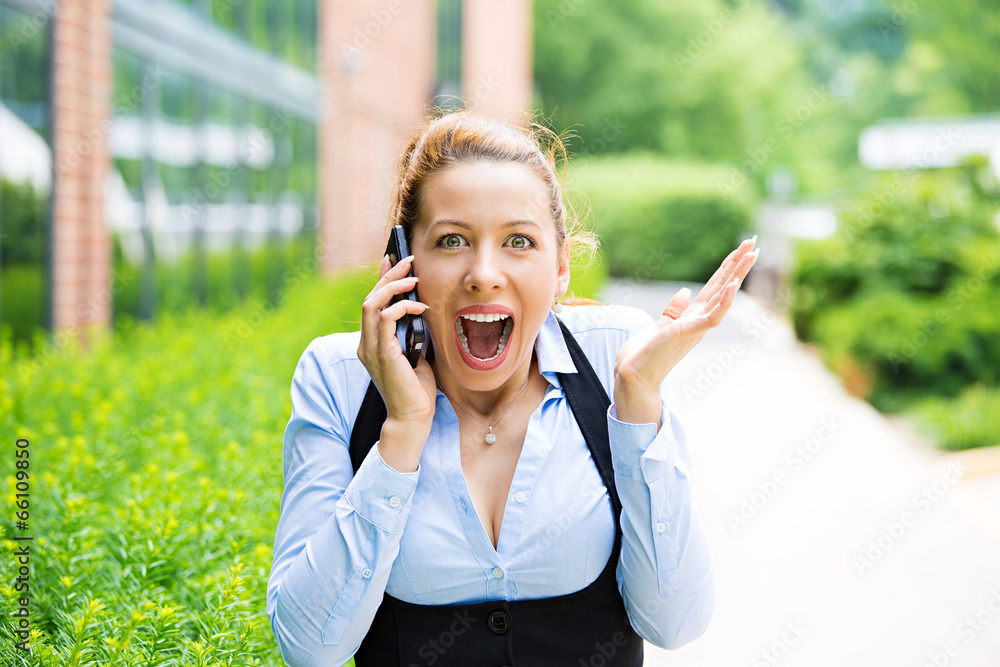 Business woman on phone, outdoors celebrating success Business woman on phone, outdoors celebrating success