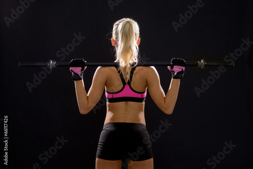 sporty woman exercising with barbell