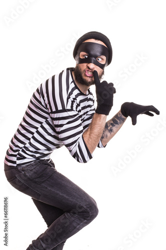 A thief with mask quietly slinking