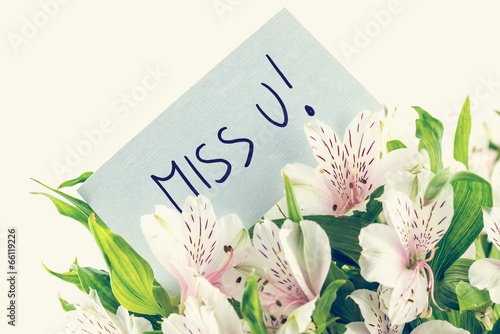 Bunch of white tiger lillies with a Miss u card photo