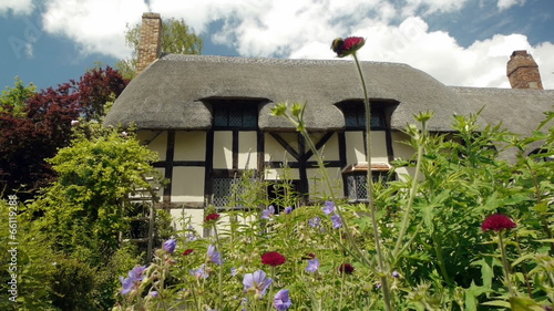 Medieval half-timbered English cottage seen from the garden.