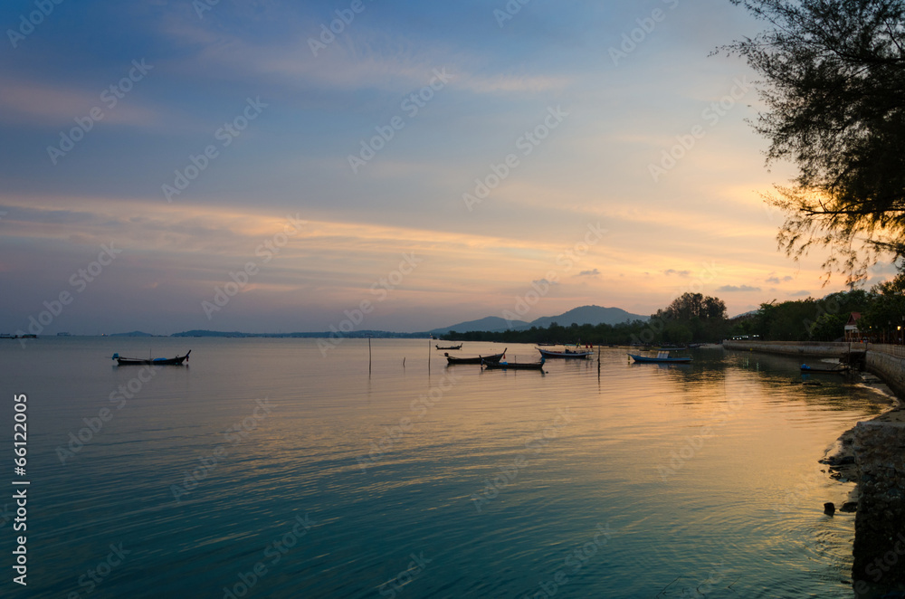 Traditional thai long tail boats at sunset