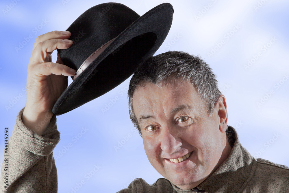Fototapeta premium Man lifts hat in greeting