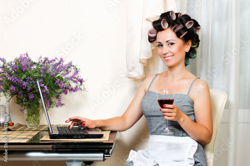 beautiful woman in the kitchen with notebook