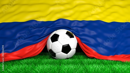 Soccer ball with Colombian flag on football field closeup
