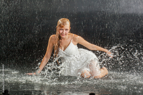 Blonde girl in dress in water studio