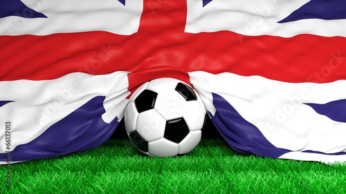 Soccer ball with British flag on football field closeup