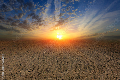 sunset over ploughed field