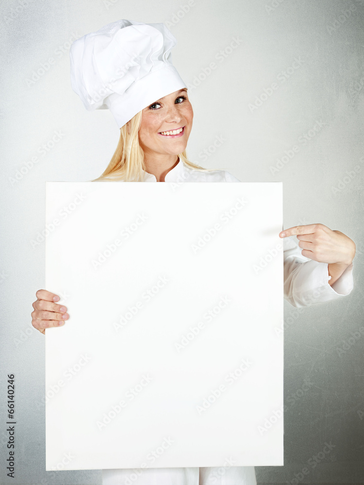 Female cook shows white blackboard with copyspace Female cook shows white blackboard with copyspace