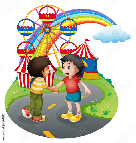 Boys handshaking in front of the carnival