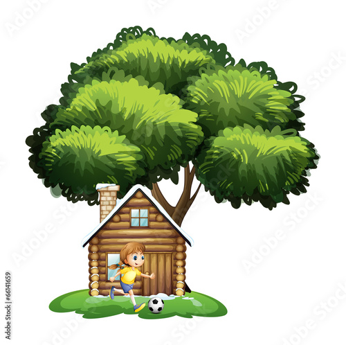 A girl playing soccer outside the house