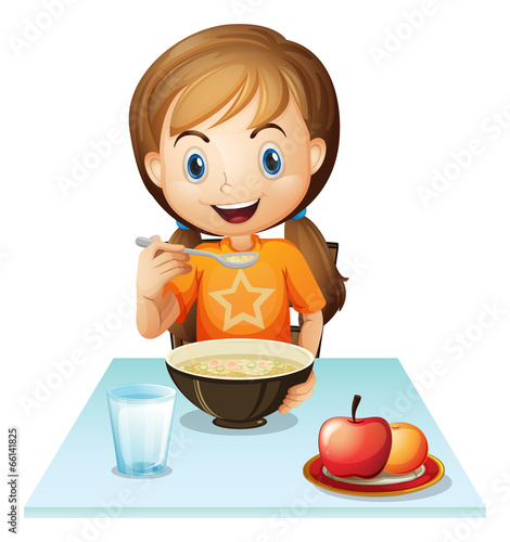 A smiling girl eating her breakfast