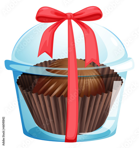 A cupcake inside a container with a red ribbon