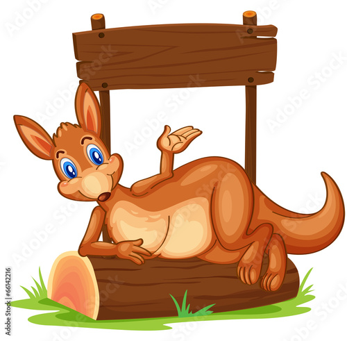 A kangaroo under the empty wooden signboard