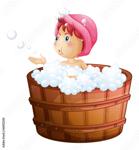 A young girl playing with the bubbles while taking a bath
