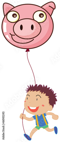 A boy holding a pig balloon