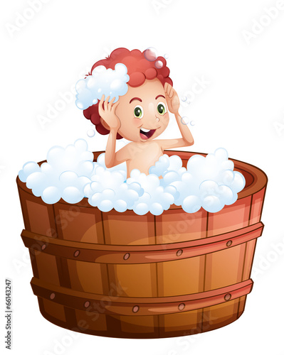 A smiling young boy inside the wooden bathtub