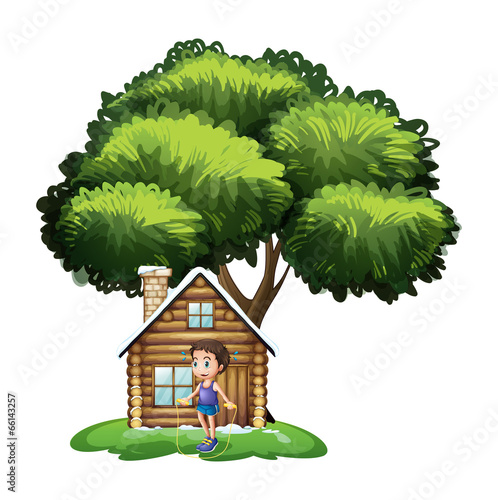A boy playing outside the wooden house