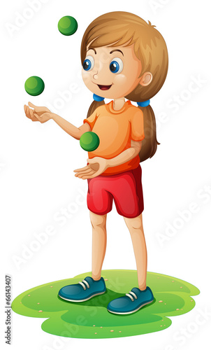 A young girl playing with the three green balloons