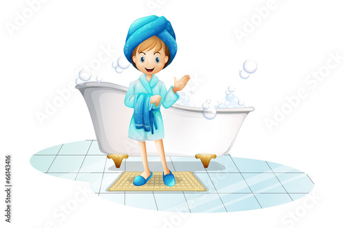 A happy girl wearing a blue robe and a blue shower cap