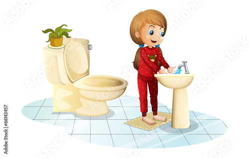 A young girl washing her hands