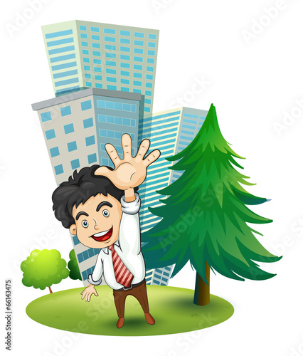 A happy businessman near the pine tree