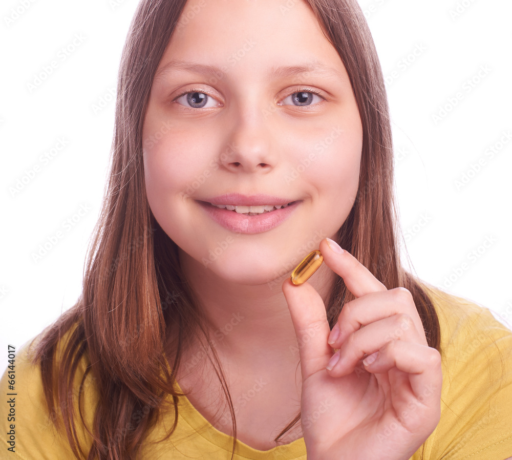 teenager girl with a pill isolated on white teenager girl with a pill isolated on white
