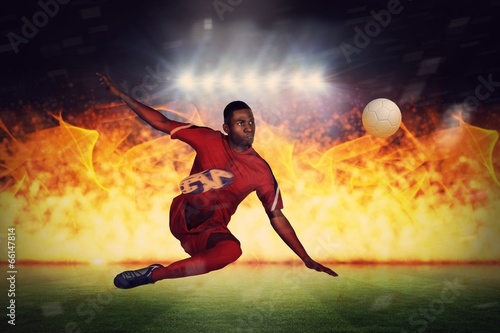 Composite image of football player in red kicking © WavebreakmediaMicro