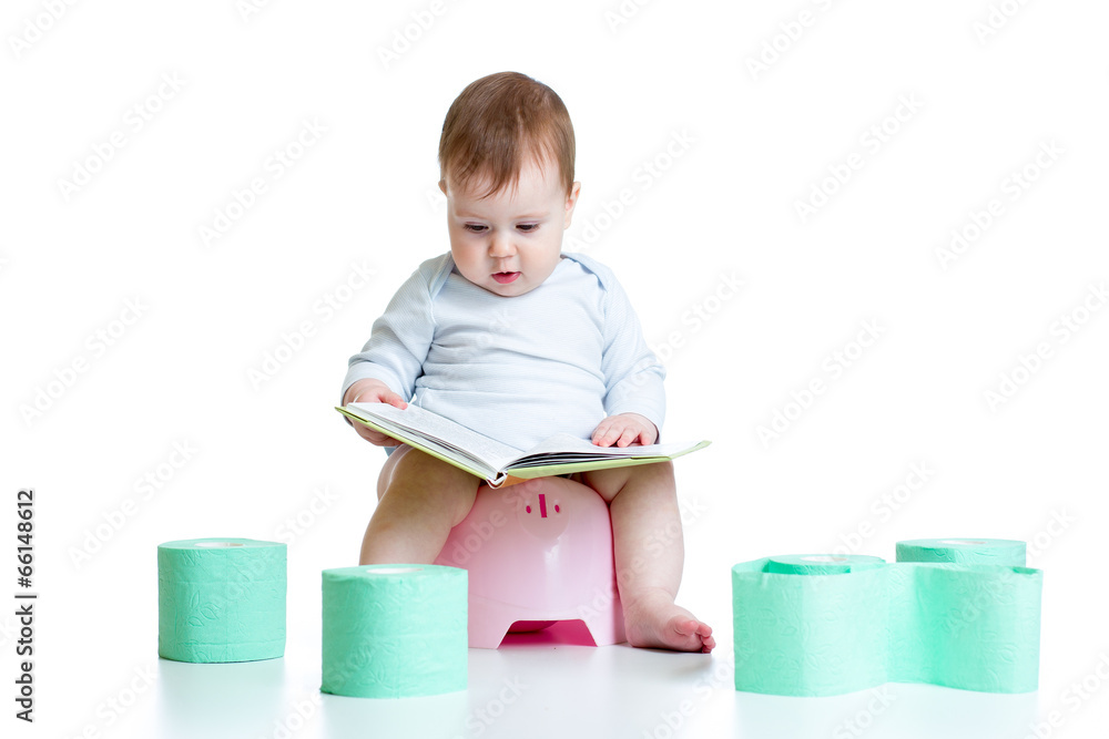 baby girl sitting on chamberpot with book baby girl sitting on chamberpot with book