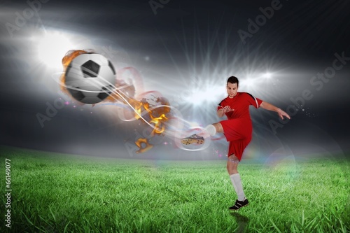 Composite image of football player in red kicking © WavebreakmediaMicro