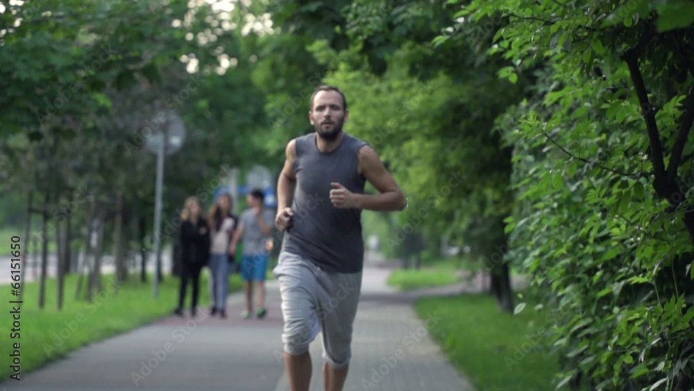 Man jogging in city park, super slow motion, shot at 480fps Man jogging in city park, super slow motion, shot at 480fps