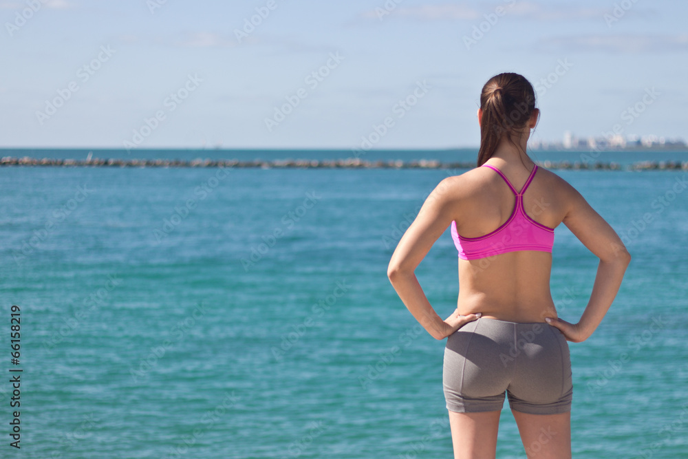 Fit woman looking at the ocean Fit woman looking at the ocean