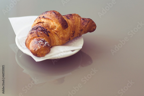 fresh croissants on a plate, vintage tone. photo