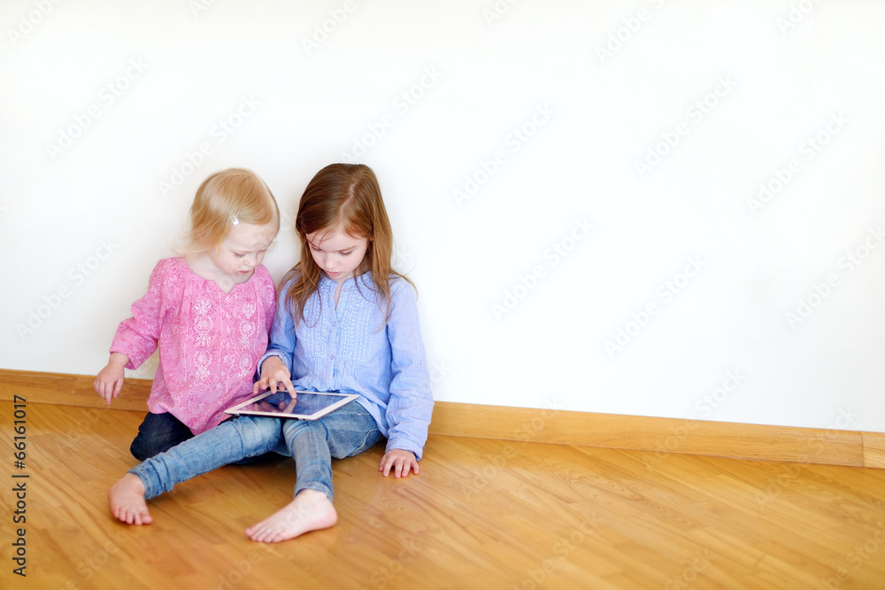 Two children playing on a digital tablet