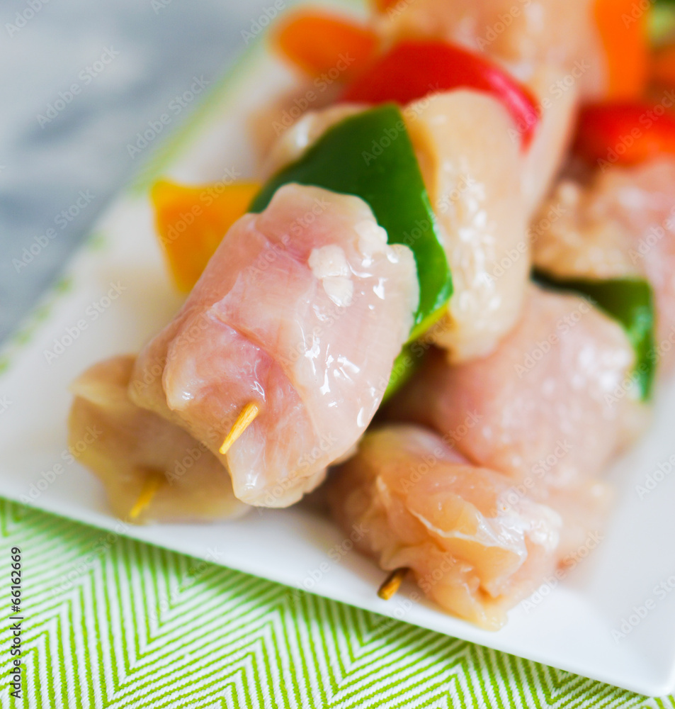 raw chicken kebabs with baked potatoes