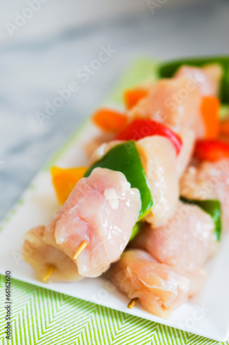 raw chicken kebabs with baked potatoes