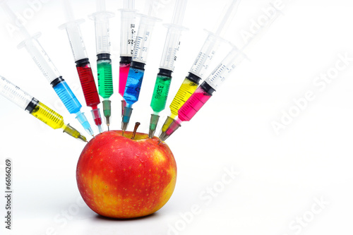 gmo apple surrounded by needles with chemical substances