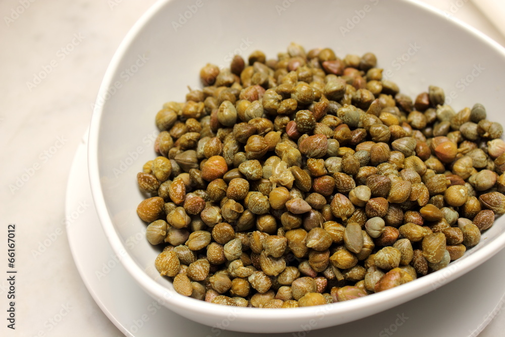Marinated capers on a white plate Marinated capers on a white plate