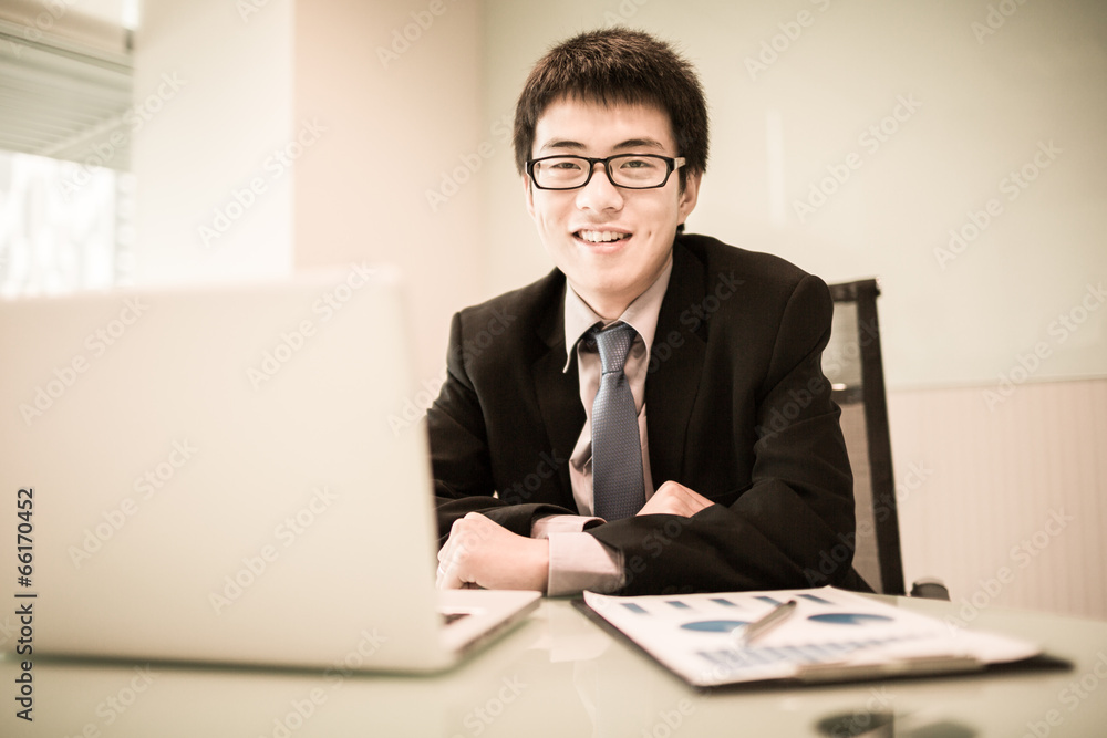 Young handsome man using laptop in his office Young handsome man using laptop in his office