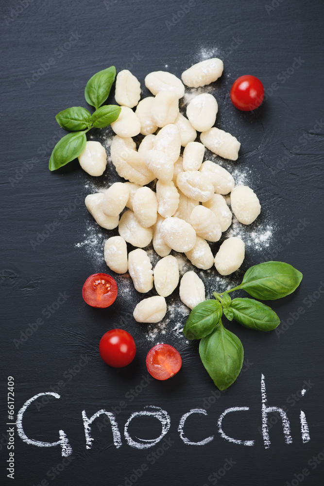 Traditional italian gnocchi, black wooden background, above view Traditional italian gnocchi, black wooden background, above view