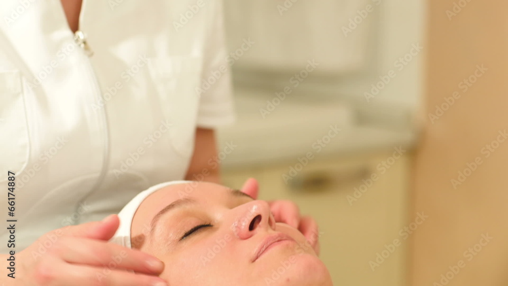 Therapist doing a facial massage at beauty spa Therapist doing a facial massage at beauty spa