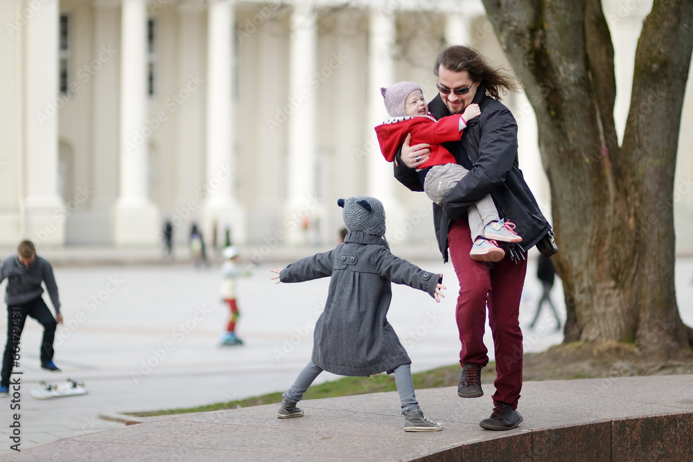 Father and two kids running and laughing Father and two kids running and laughing